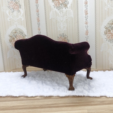 miniaturowa śliwkowa sofa z dwoma poduszeczkami